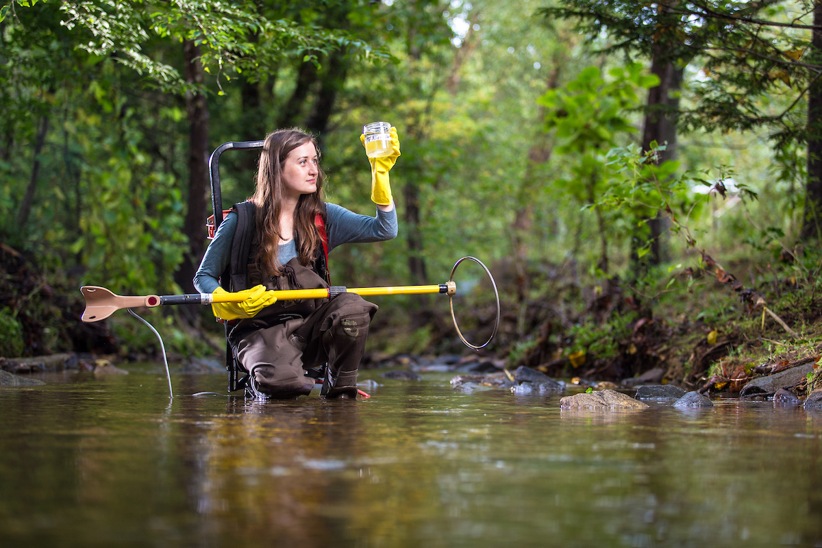 A student takes river samples